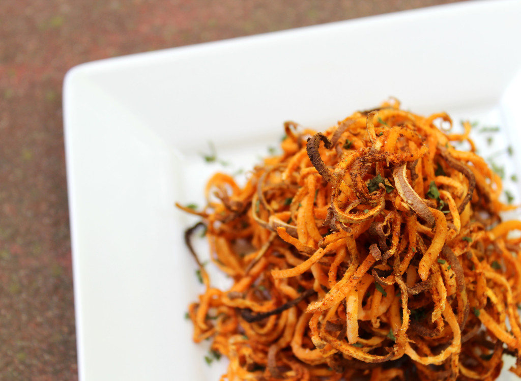 Spicy Spiralized Sweet Potato Fries | Strength and Sunshine @RebeccaGF666 Take your fries to a whole new level. These spicy sweet potato fries are spiralized and baked for the ultimate crispness and seasoned to a spiciness of your liking. Gluten-free, vegan, allergy-free, paleo, and Whole 30 approved, these fries will make your summer cook-outs a little livelier!