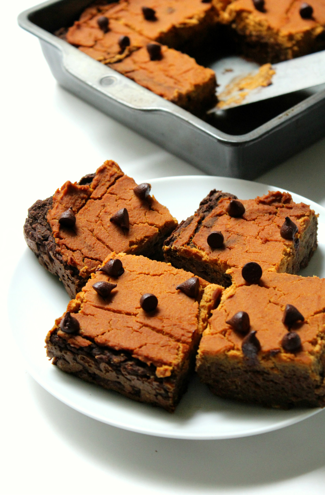 Pumpkin Peanut Butter Layer Brownies | Strength and Sunshine @RebeccaGF666 Where pumpkin, peanut, and chocolate combine! Pumpkin Peanut Butter Layer Brownies will make you rethink your definition of brownie. These gluten-free and vegan brownies are the healthiest of holiday indulgences, you won't have to stop at one! They can be dessert or breakfast!