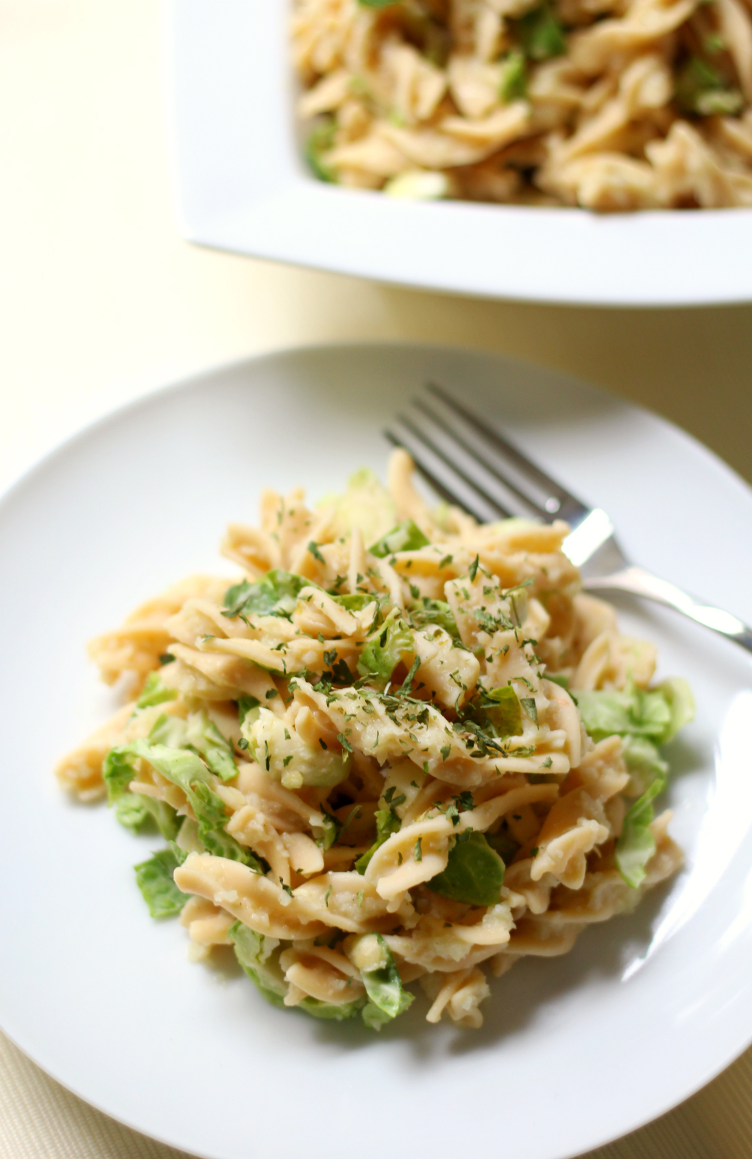 Rotini Pasta Alfredo with Shaved Brussels Sprouts | Strength and Sunshine @RebeccaGF666 A healthy veggie-packed, grain-free rotini pasta Alfredo that you won't know is gluten-free or vegan! The ultimate comfort food dinner recipe you can make to nourish the whole family (and get them to eat brussels sprouts)!