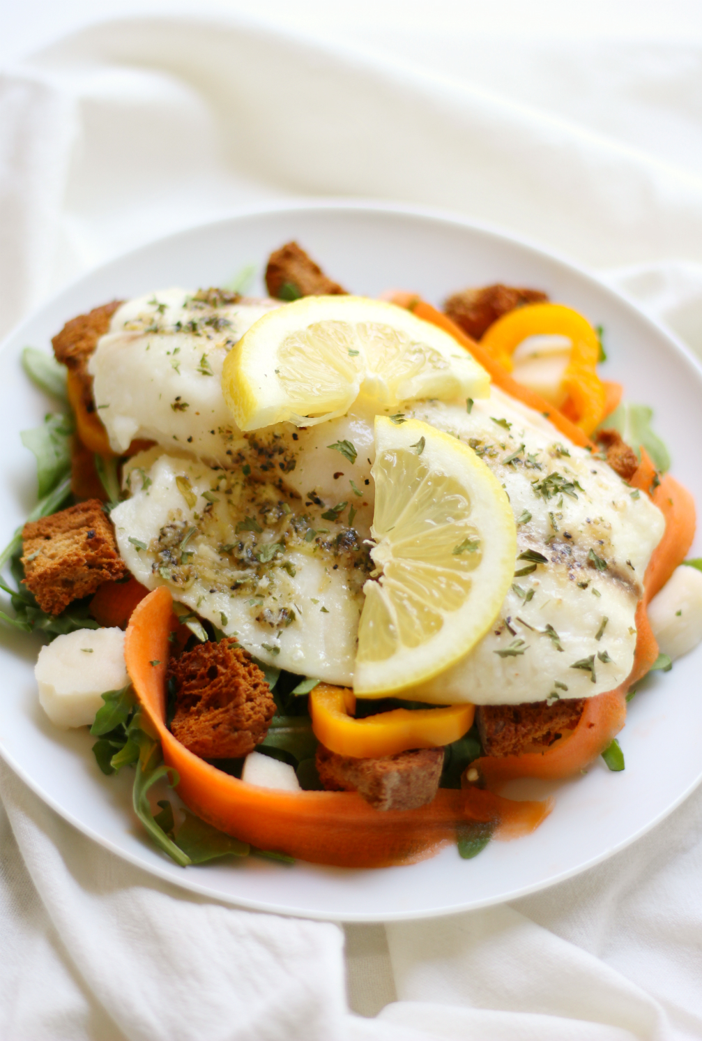Lemon Pepper Tilapia + Spring Arugula Salad & Homemade Garlic Herb Croutons | Strength and Sunshine @RebeccaGF666 A simple spring weeknight dinner recipe for lemon pepper tilapia with a fresh arugula salad and homemade gluten-free, dairy-free garlic herb croutons! Ready in 20 minutes or less so you have time to sit down and enjoy!