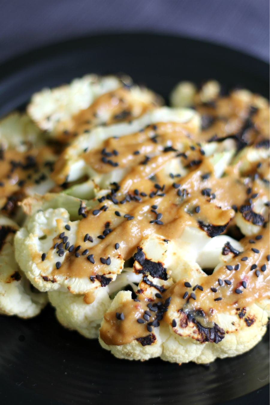 Grilled Ginger Cauliflower Steaks with Tahini Sauce | Strength and Sunshine @RebeccaGF666 Thick slices of cauliflower, rubbed with spices and grilled to tender perfection. Served with a slightly spicy tahini sauce, these grilled ginger cauliflower steaks need to hit your grill stat! Gluten-free, vegan, paleo, Whole 30, and nut-free! A healthy dinner recipe!
