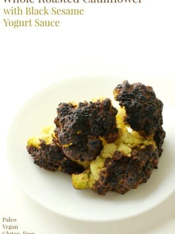 Whole Roasted Cauliflower with Black Sesame Yogurt Sauce | Strength and Sunshine @RebeccaGF666 A Whole Roasted Cauliflower with Black Sesame Yogurt Sauce baked to tender perfection. This hearty gluten-free, nut-free, vegan, and paleo main dish will satisfy even the biggest of cauliflower skeptics. A recipe full of flavor and comfort for one memorable dinner!
