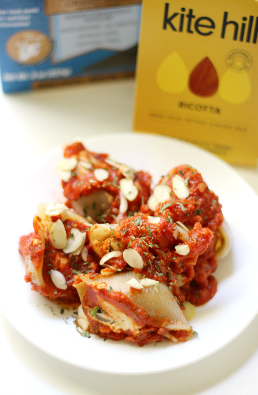 Gluten-Free Stuffed Shells with Vegan Almond Ricotta | Strength and Sunshine @RebeccaGF666 A classic Italian dinner recipe made-over so everyone can enjoy. Gluten-Free Stuffed Shells with Vegan Almond Ricotta and a homemade sun-dried tomato sauce! A cozy family meal that leaves bellies full and hearts warm!