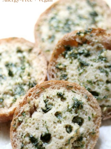 Gluten-Free Sourdough Garlic Bread (Vegan, Allergy-Free) | Strength and Sunshine @RebeccaGF666 What dinner table is complete without some garlic bread? This Gluten-Free Sourdough Garlic Bread is a delicious, vegan, and top-8 allergy-free twist on the Italian classic. Using gluten-free sourdough buns, these garlicky delights are ready in 10 minutes! #glutenfree #vegan #dairyfree #allergyfree #garlicbread #sourdough #italianfood