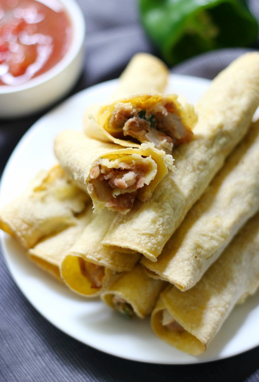 Gluten-Free Baked Pinto Bean Taquitos (Vegan, Allergy-Free) | Strength and Sunshine @RebeccaGF666 Change up your taco routine with the Mexican "rolled taco"! Gluten-Free Baked Pinto Bean Taquitos that are vegan, top 8 allergy-free, require no oil, and perfect as a dinner recipe or fun appetizer bite to feed a crowd! A spicy pinto bean filling, simply rolled in corn tortillas! #taquitos #glutenfree #vegan #mexicanfood #strengthandsunshine