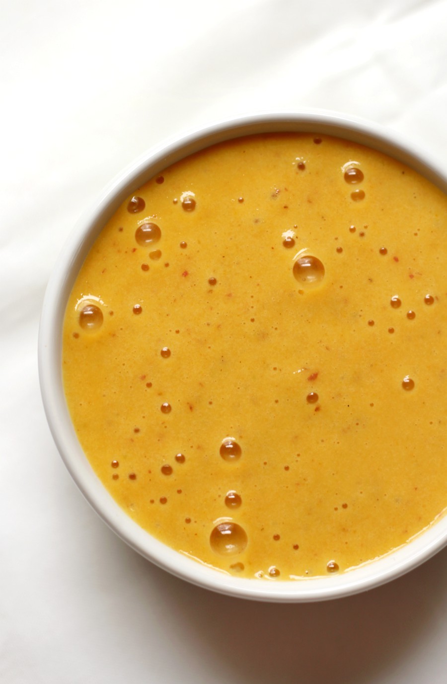 Creamy Nut-Free Vegan Nacho Cheese Sauce (Gluten-Free, Paleo, Allergy-Free) | Strength and Sunshine @RebeccaGF666 No dairy needed in this Creamy Nut-Free Vegan Nacho Cheese Sauce! Low-fat, gluten-free, paleo, and allergy-free; everyone can enjoy some healthy dipping! A tummy-friendly recipe, made quick & easy in a blender. You'll be using this sauce for more than just chips! #cheesesauce #nachocheesesauce #dairyfree #vegan #nutfree #strengthandsunshine