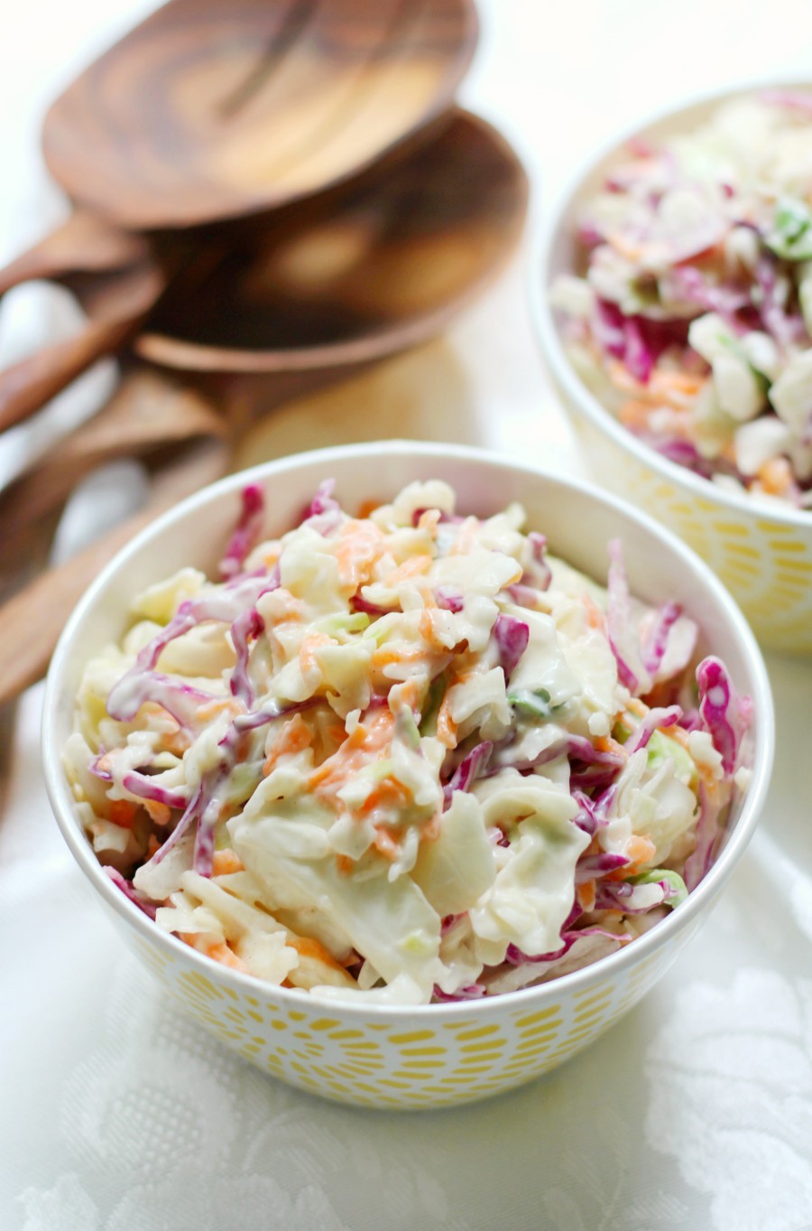 coleslaw-spoon-two-bowls-table