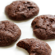 bitten-double-chocolate-chunk-brownie-cookie-on-white-table-pin