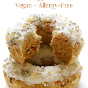 stack of baked gluten-free carrot cake doughnuts with vegan cream cheese frosting