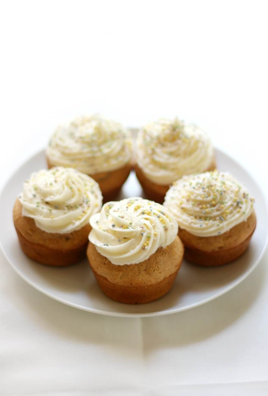 full plate of vegan cream cheese frosted gluten-free carrot cake cupcakes
