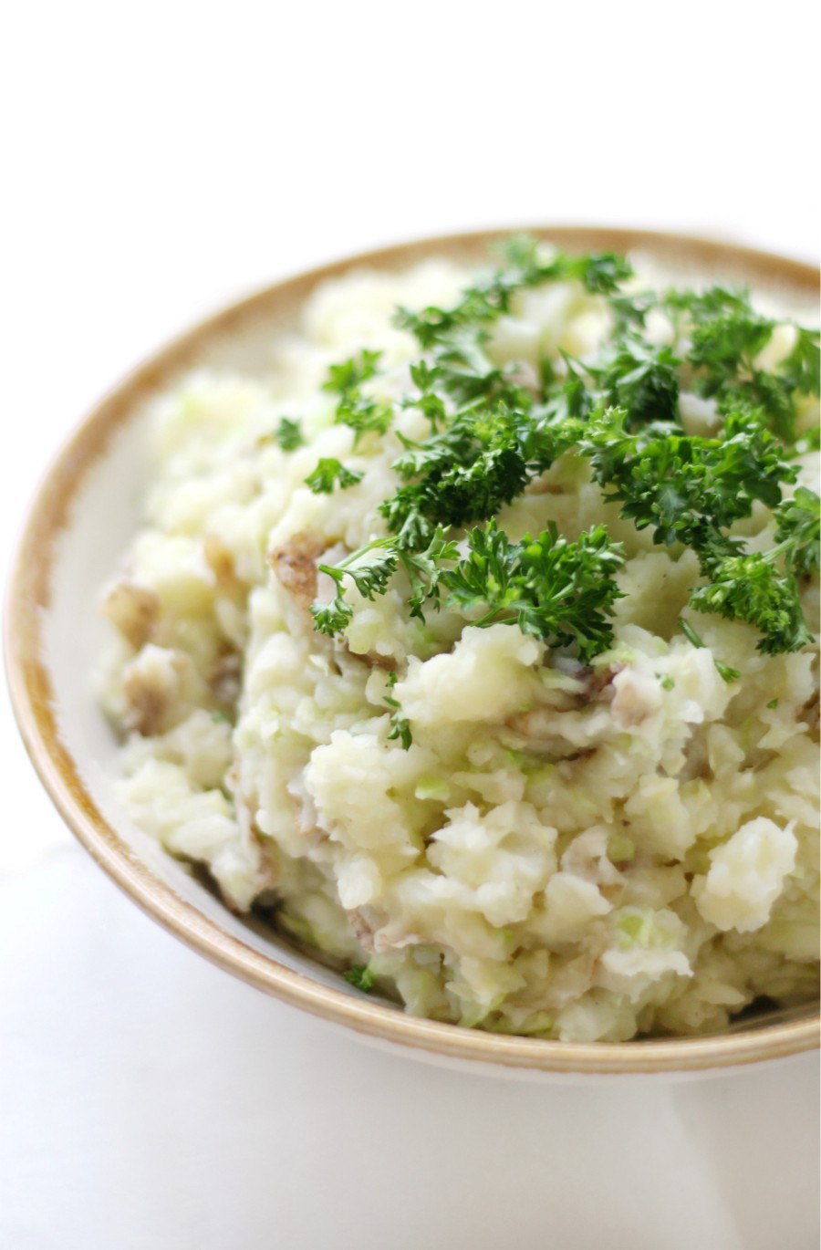 vegan-irish-colcannon-in-rimmed-bowl-on-white-background