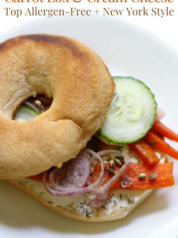 gluten-free bagel and vegan carrot lox on a white plate