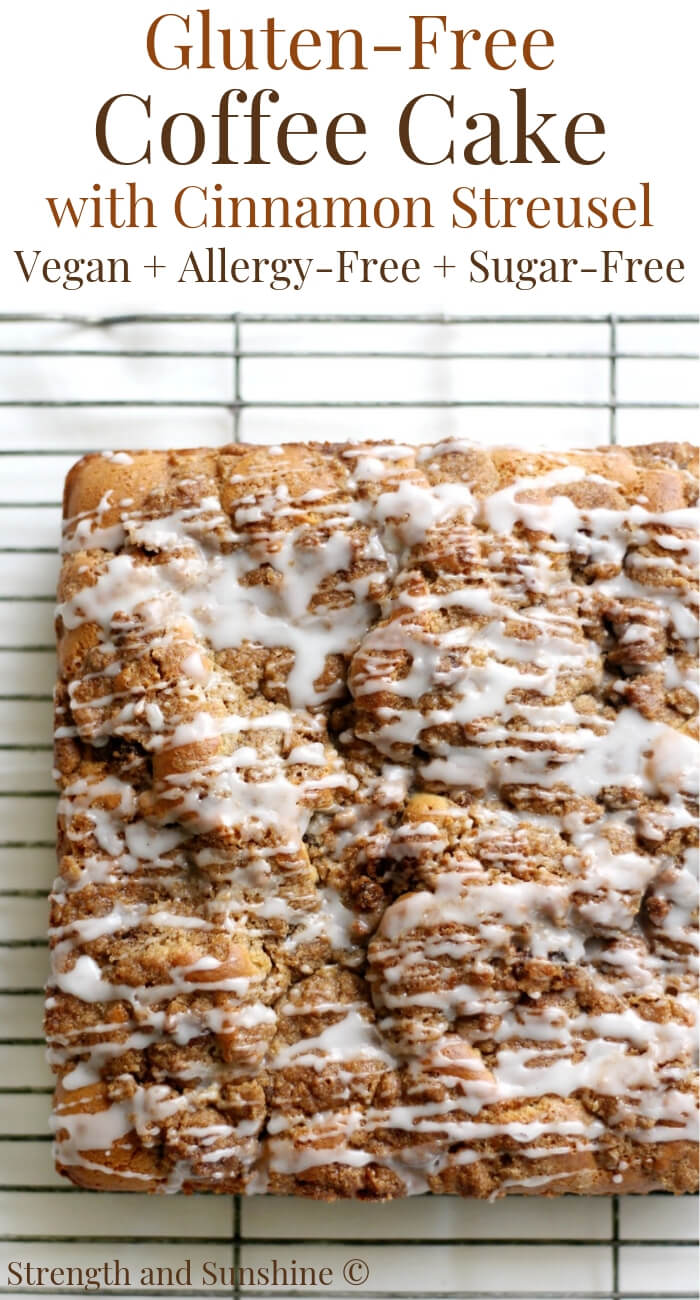 overhead view of uncut coffee cake with icing drizzle on a wire rack