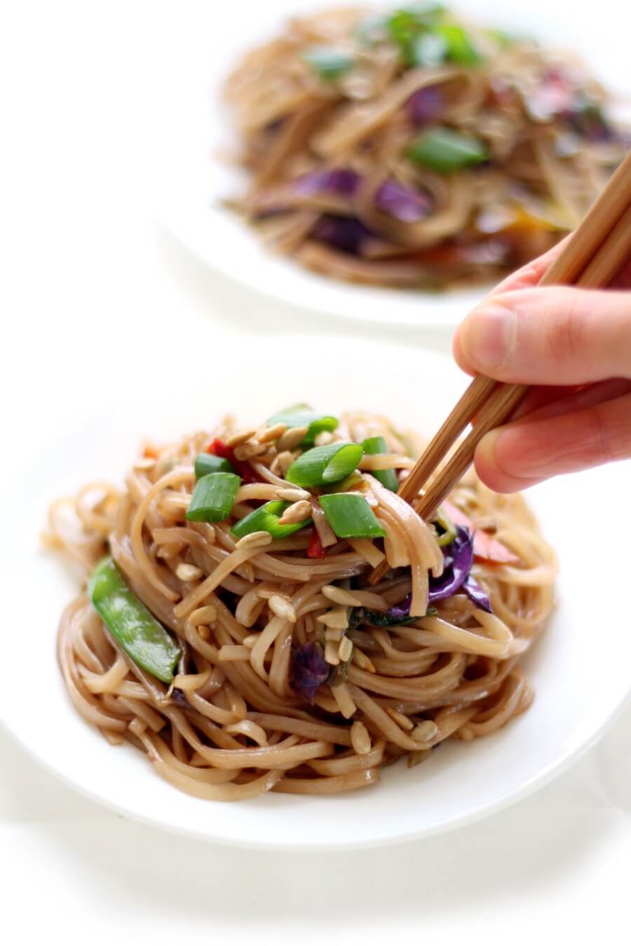 plate of easy vegan pad thai with chopsticks being used