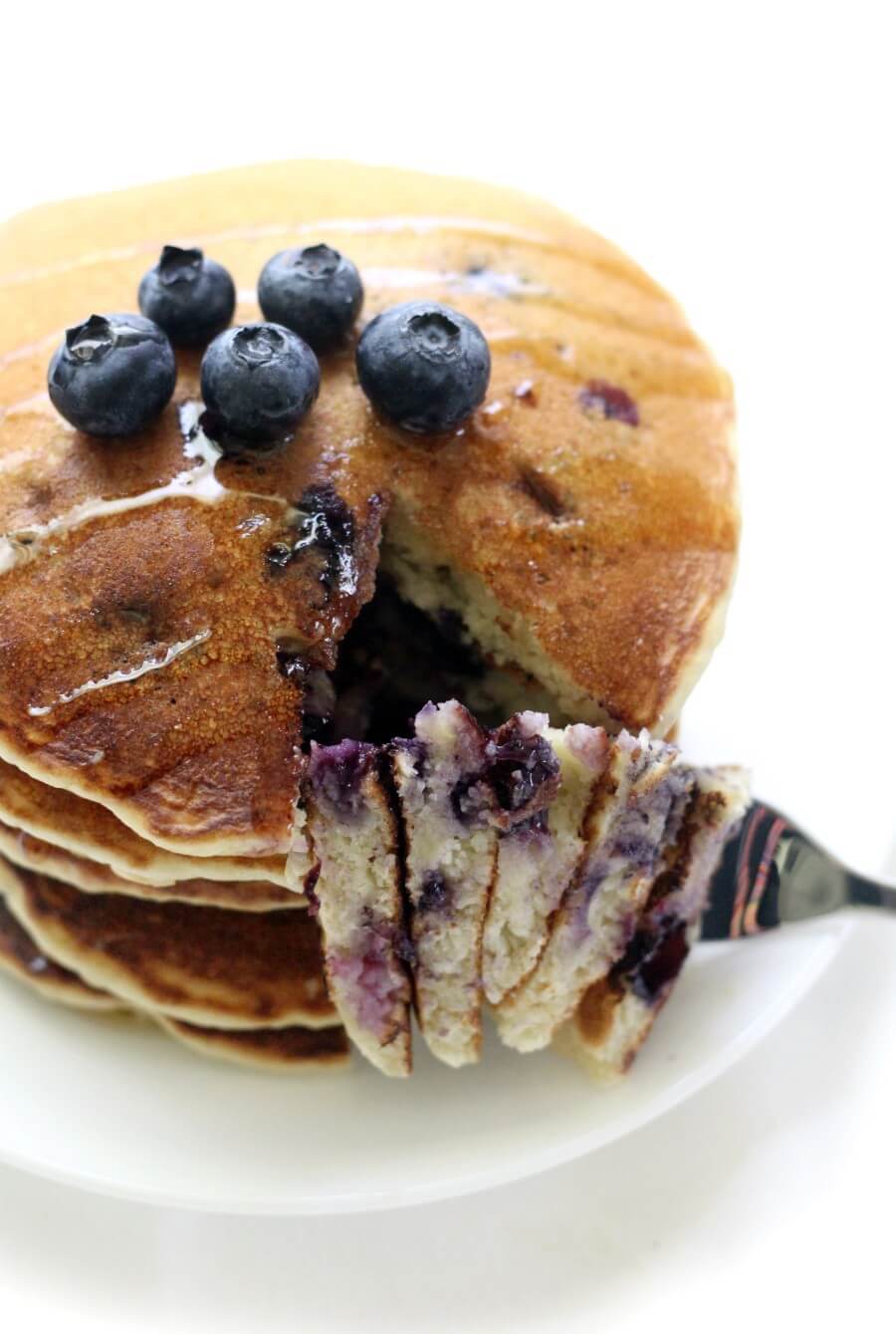 close-up of a forkful of gluten-free vegan blueberry pancakes