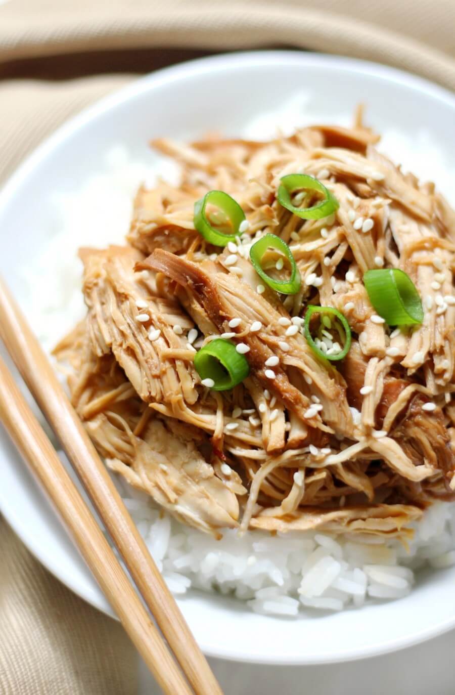 slow cooker teriyaki chicken with chopsticks over white rice