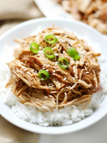 centered white bowl with rice and slow cooker teriyaki chicken
