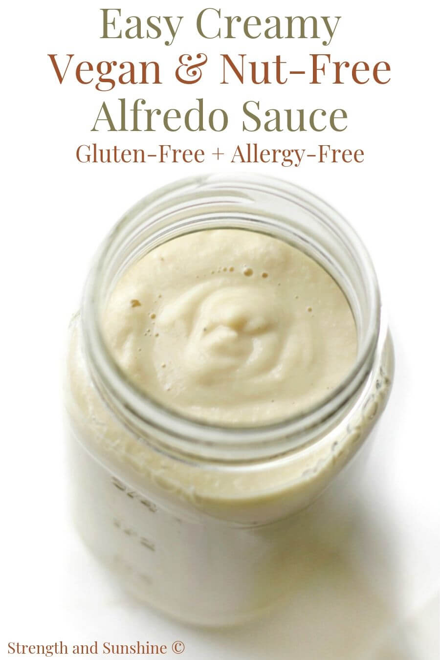 creamy vegan alfredo sauce in a a glass jar with image text