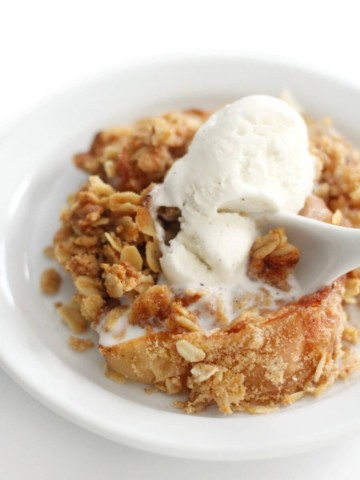 close-up of spoon scooping dairy-free ice cream and gluten-free apple crisp