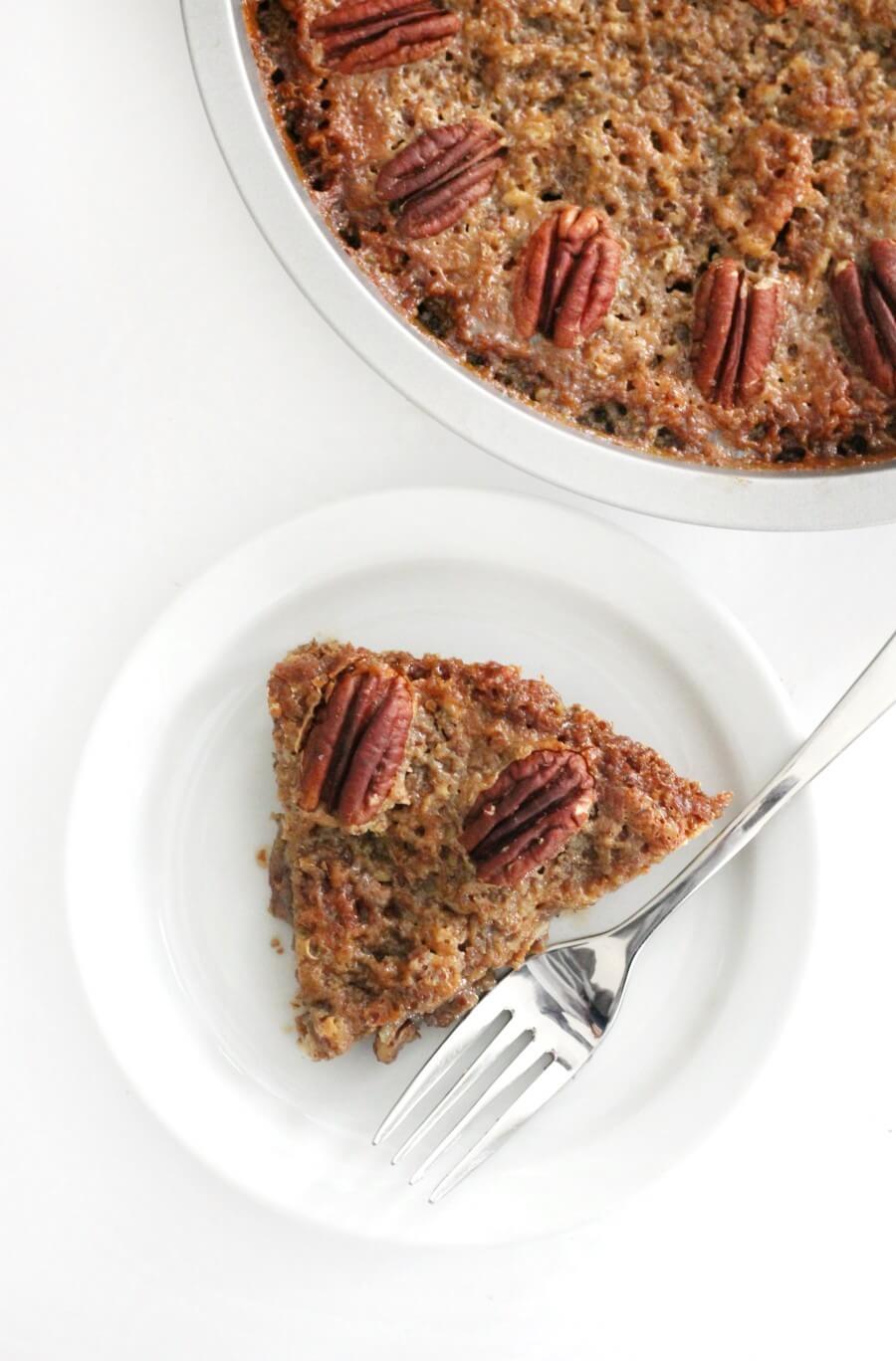 crustless pecan pie on plate with fork overhead view