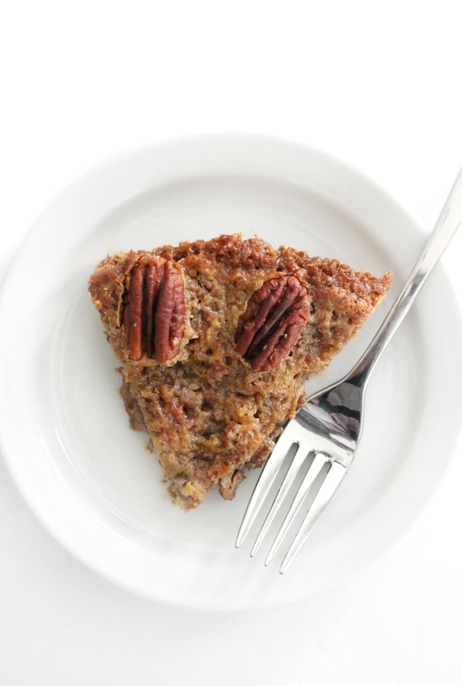 overhead view of plated crustless pecan pie on plate with fork