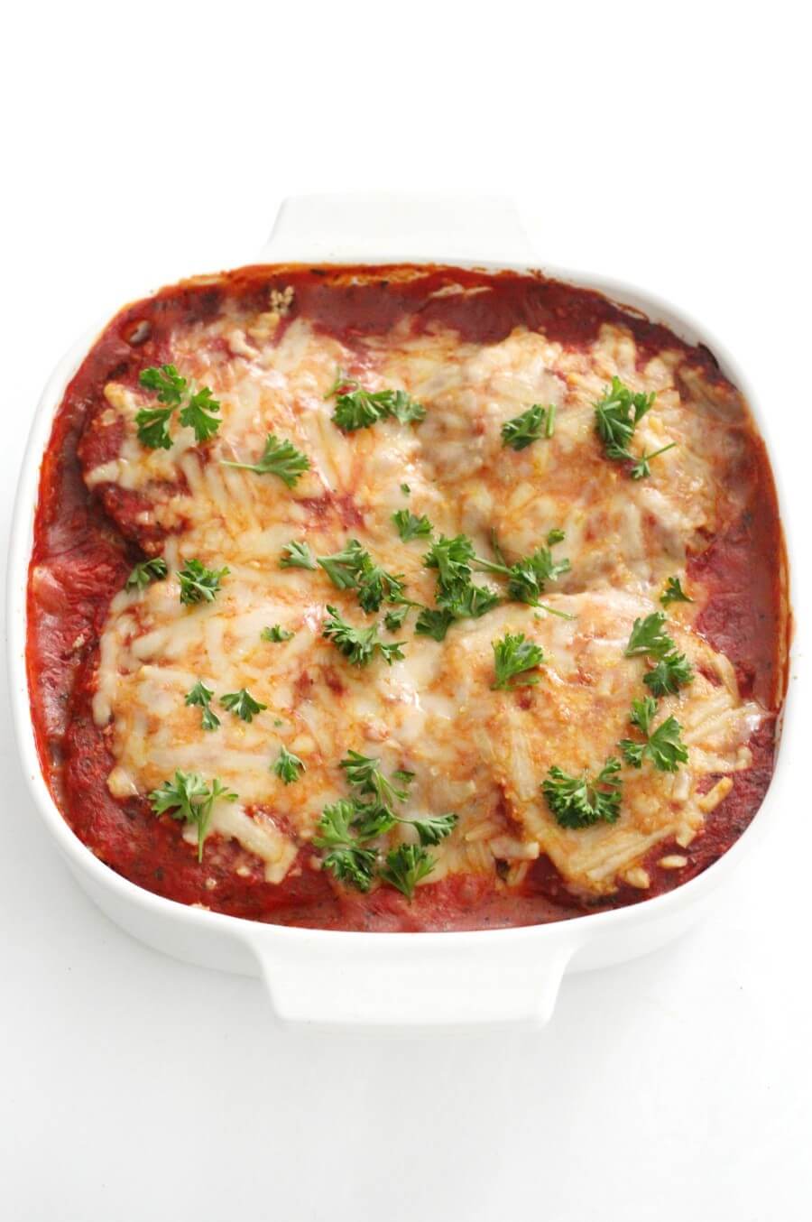 finished easy vegan eggplant parmesan in white casserole dish