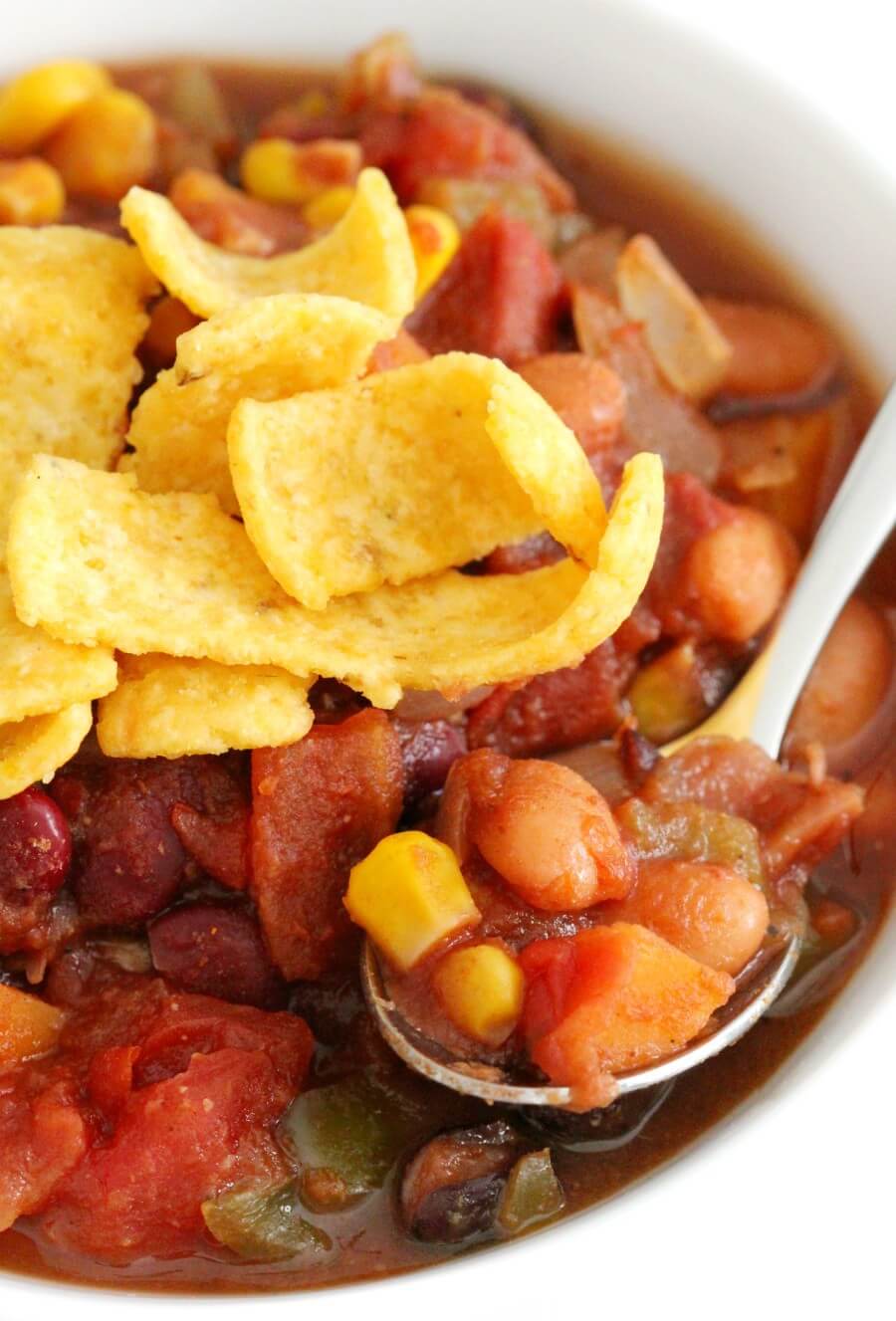 close-up of slow cooker vegetarian chili in bowl with spoon