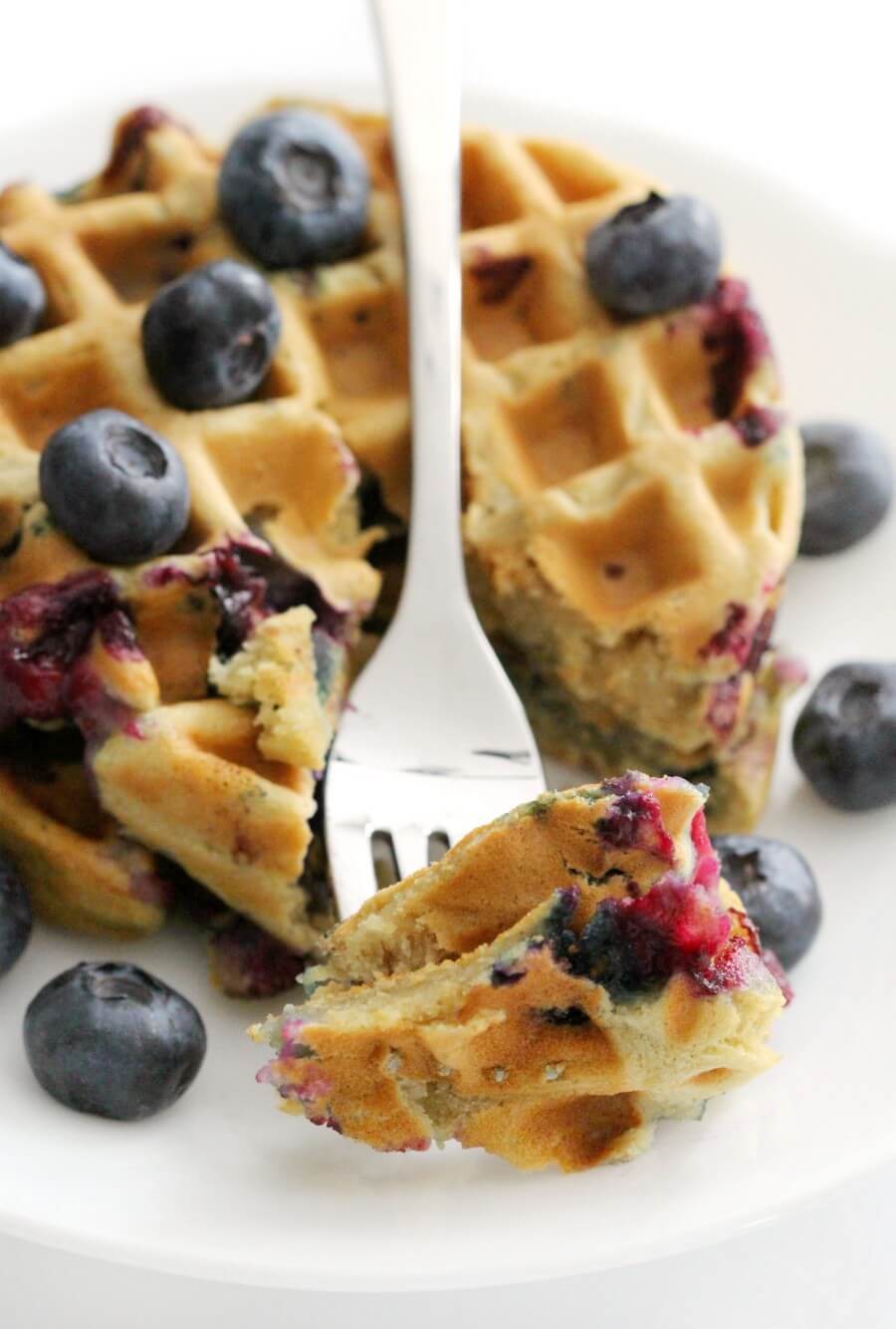 close-up of forkful of gluten-free blueberry waffles