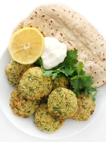 full plate of air fryer falafel with pita, lemon, yogurt, parsley