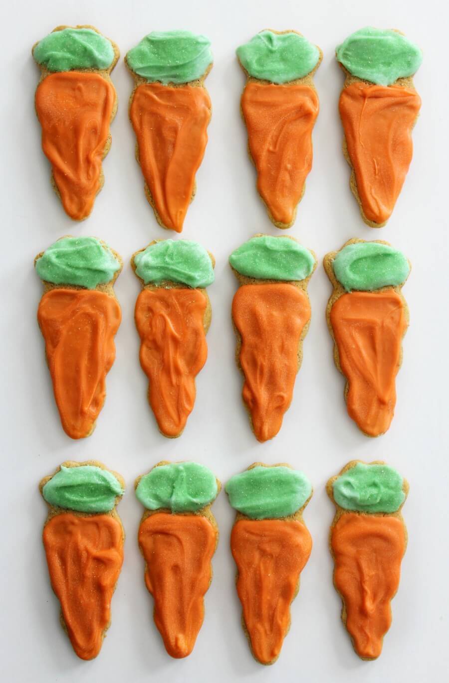 overhead view of aligned gluten-free carrot cake sugar cookies on white