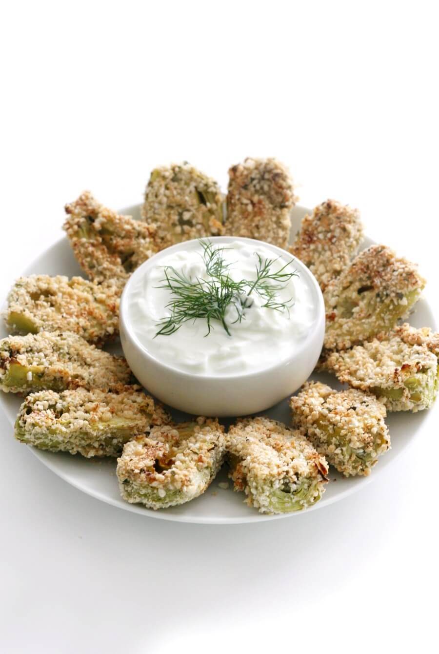 centered plate with breaded artichoke hearts and yogurt dip in middle