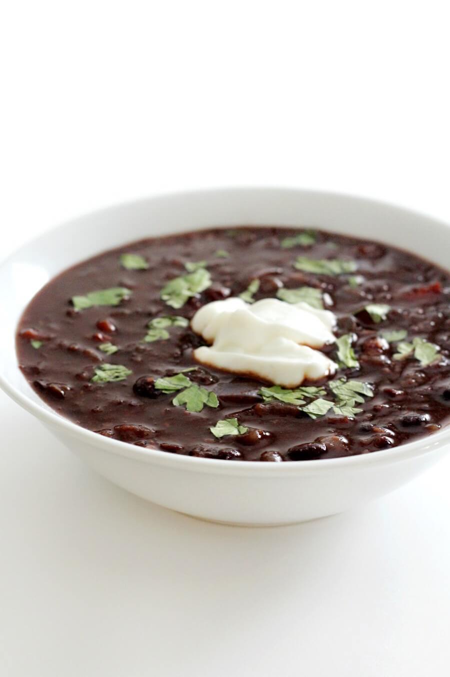 eye-level view of spicy chipotle black bean soup in white bowl