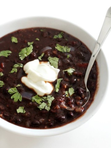 spoonful of spicy chipotle black bean soup with bowl