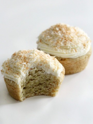 one bitten and one whole gluten-free coconut cupcakes
