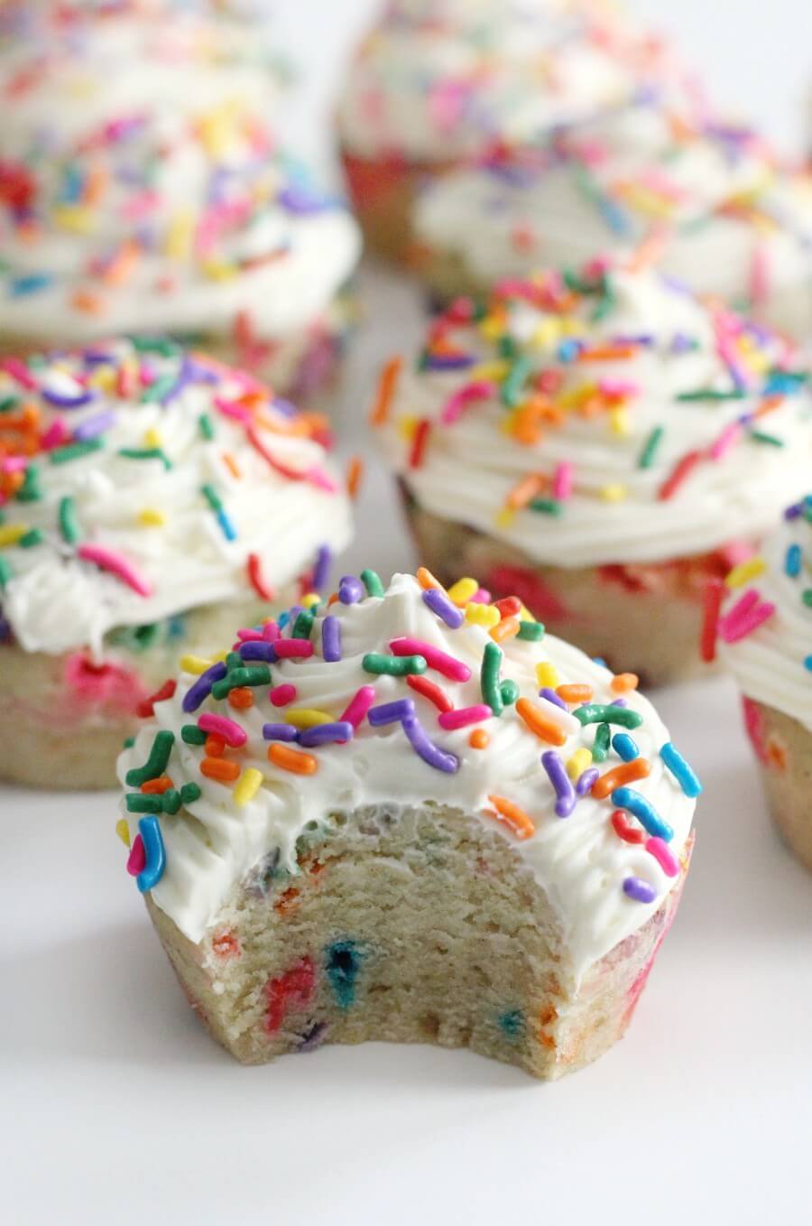half eaten gluten-free funfetti cupcakes with frosting and sprinkles