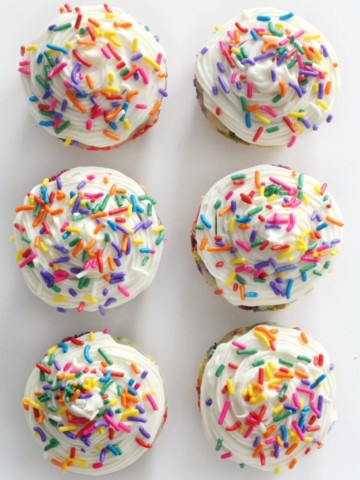 overhead view of 6 gluten-free funfetti cupcakes with vegan buttercream