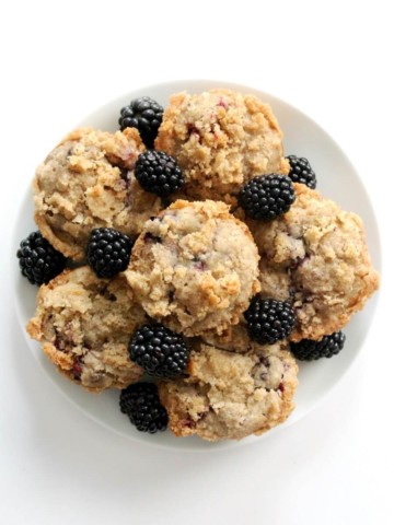 overhead view of full plate piled with gluten-free blackberry muffins with streusel topping
