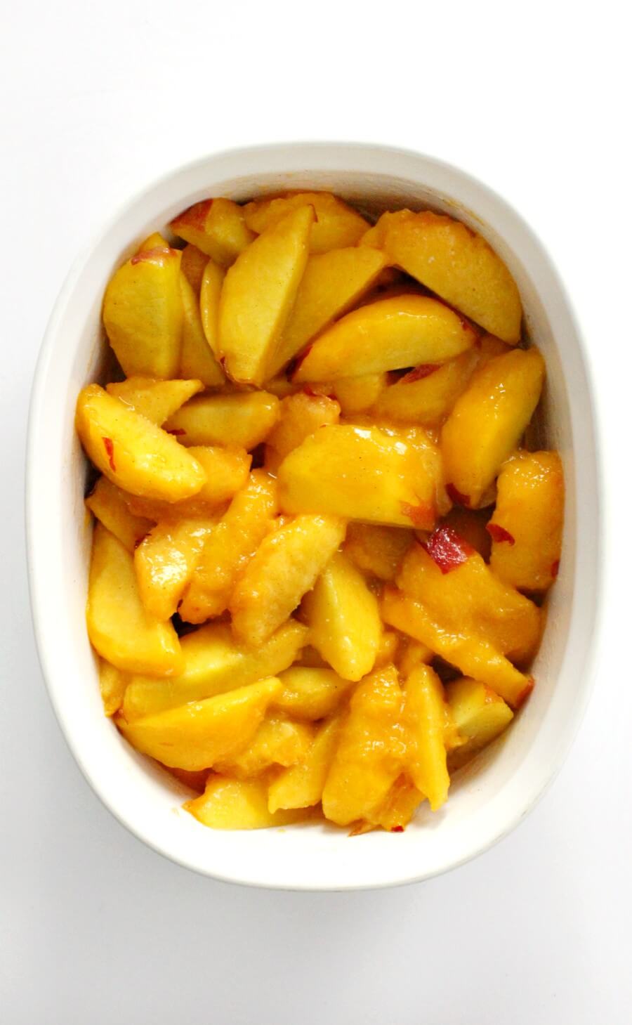 peaches in casserole dish to be baked for gluten-free peach cobbler