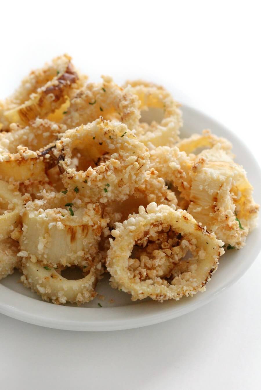 close up of crispy vegan calamari ring on white plate