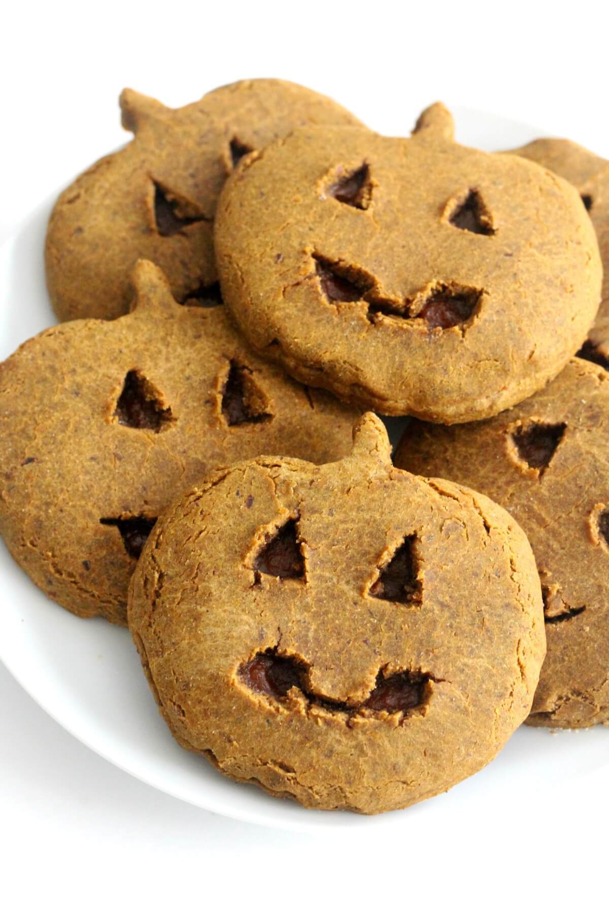 Homemade little debbie pumpkin delights cookies in pile on white plate.