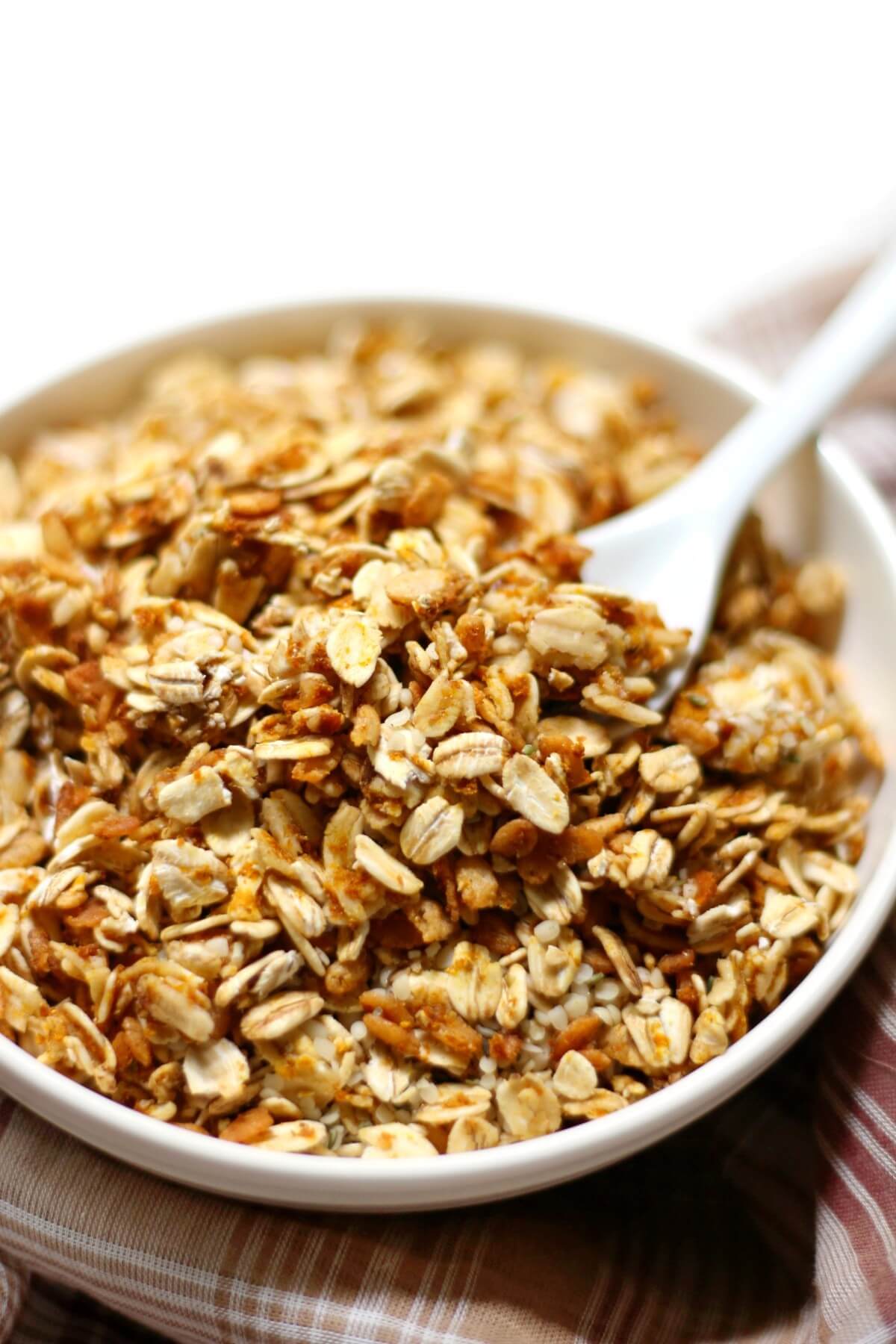 pumpkin spice granola with small white spoon