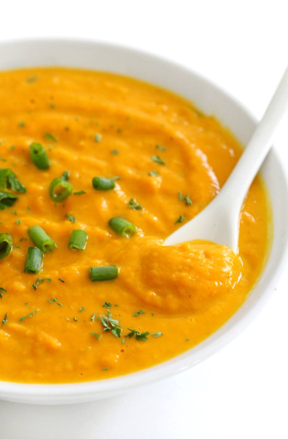 close up of vegan curried pumpkin soup spoonful