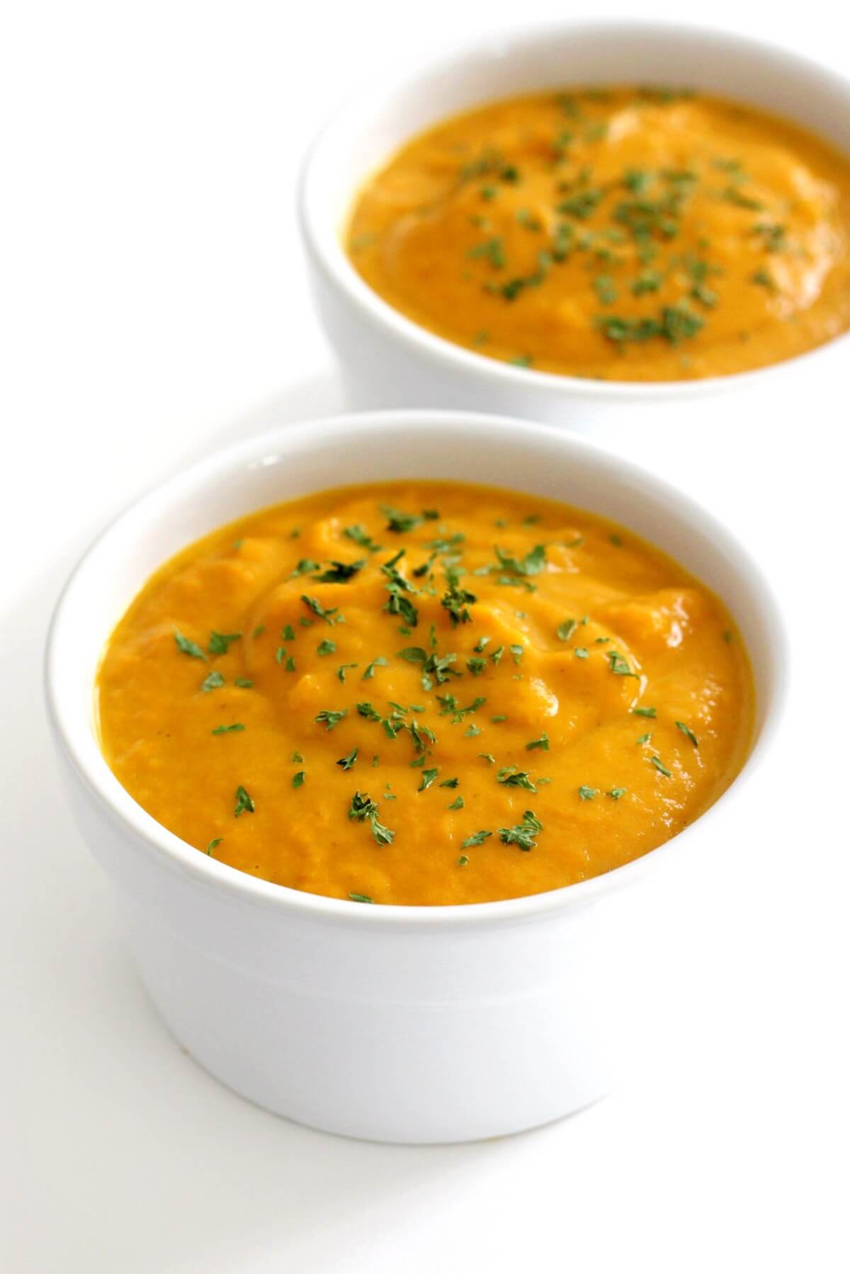 two serving bowls with vegan curried pumpkin soup