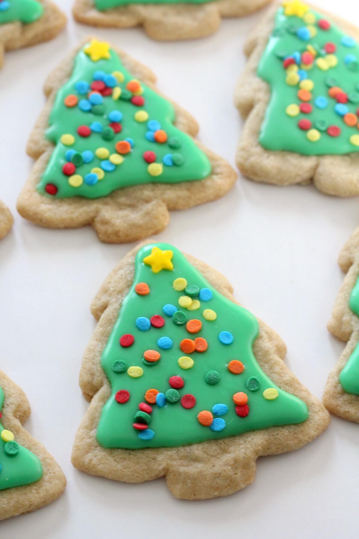 christmas tree sugar cookies with green icing and sprinkles
