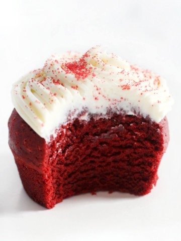 single gluten-free red velvet cupcakes with bite taken out