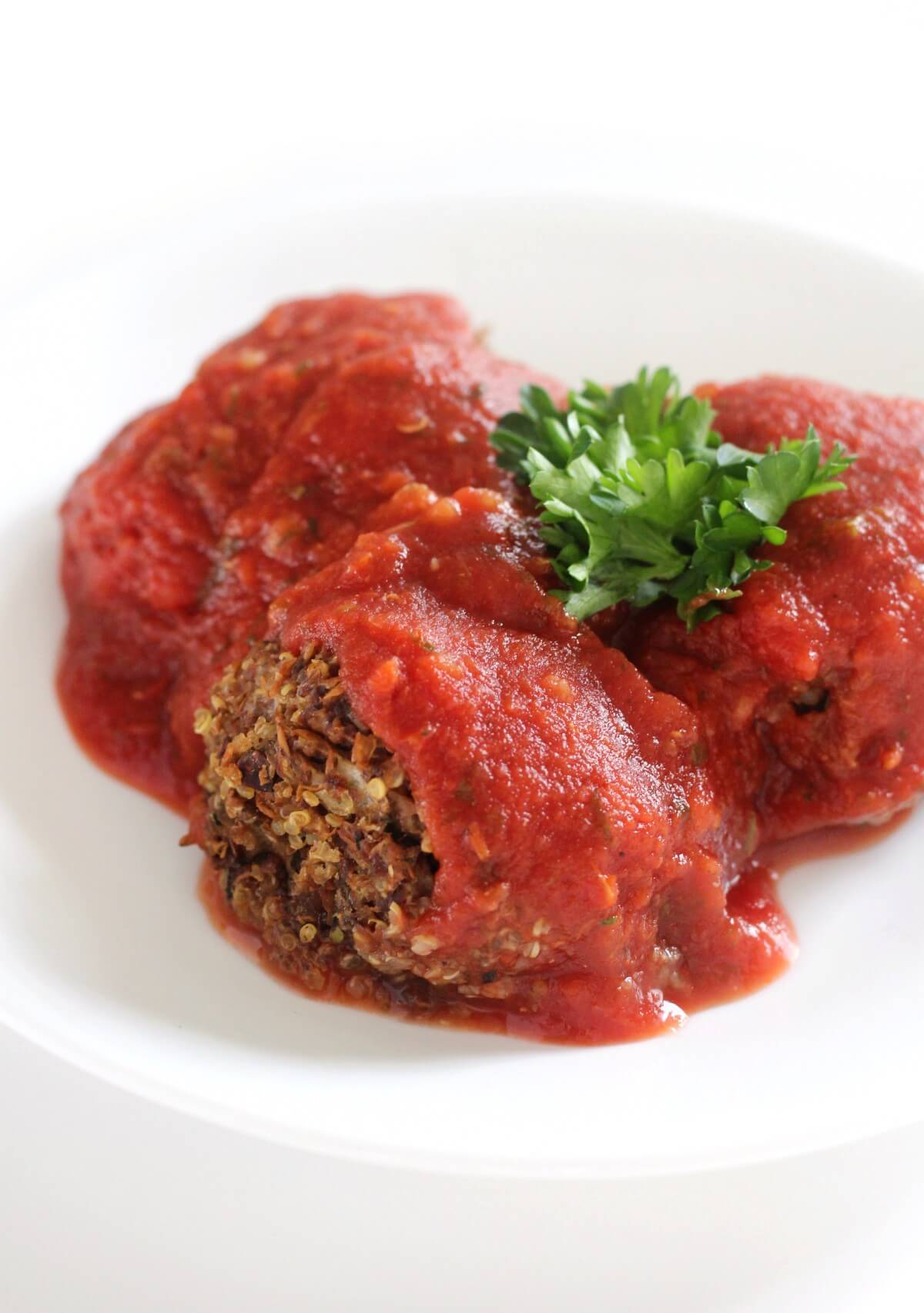 high-protein vegan meatballs with sauce on white plate