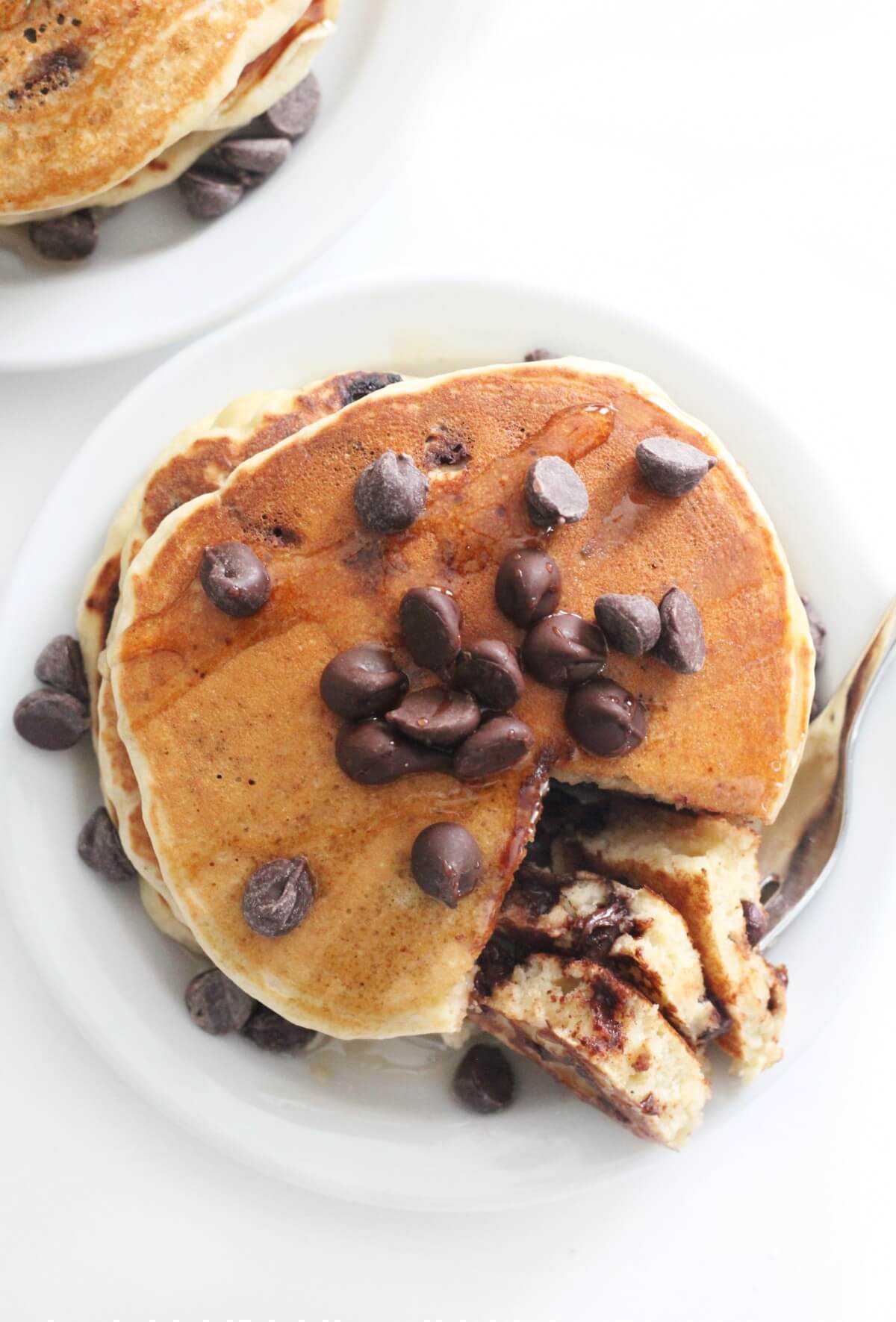 overhead view of vegan and gluten-free chocolate chip pancakes on a plate
