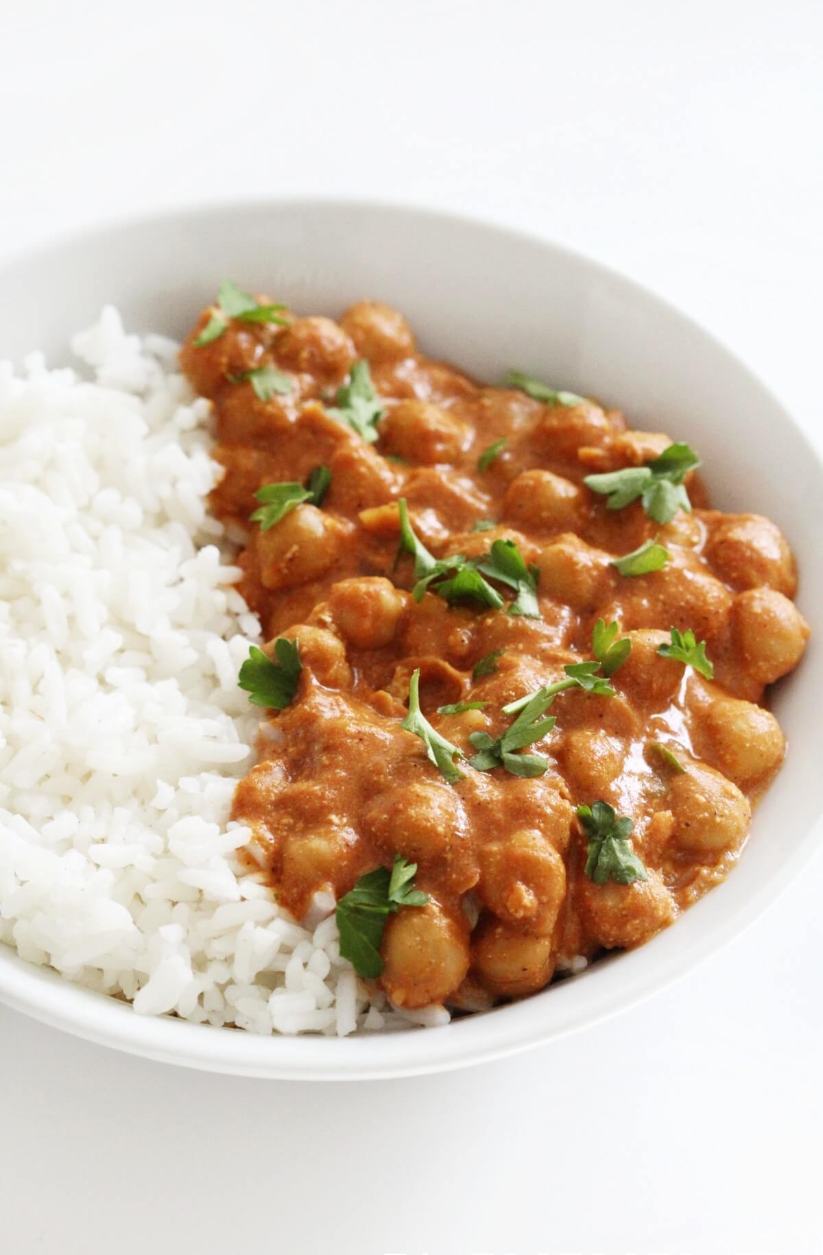 white bowl with serving of indian butter chickpeas and rice