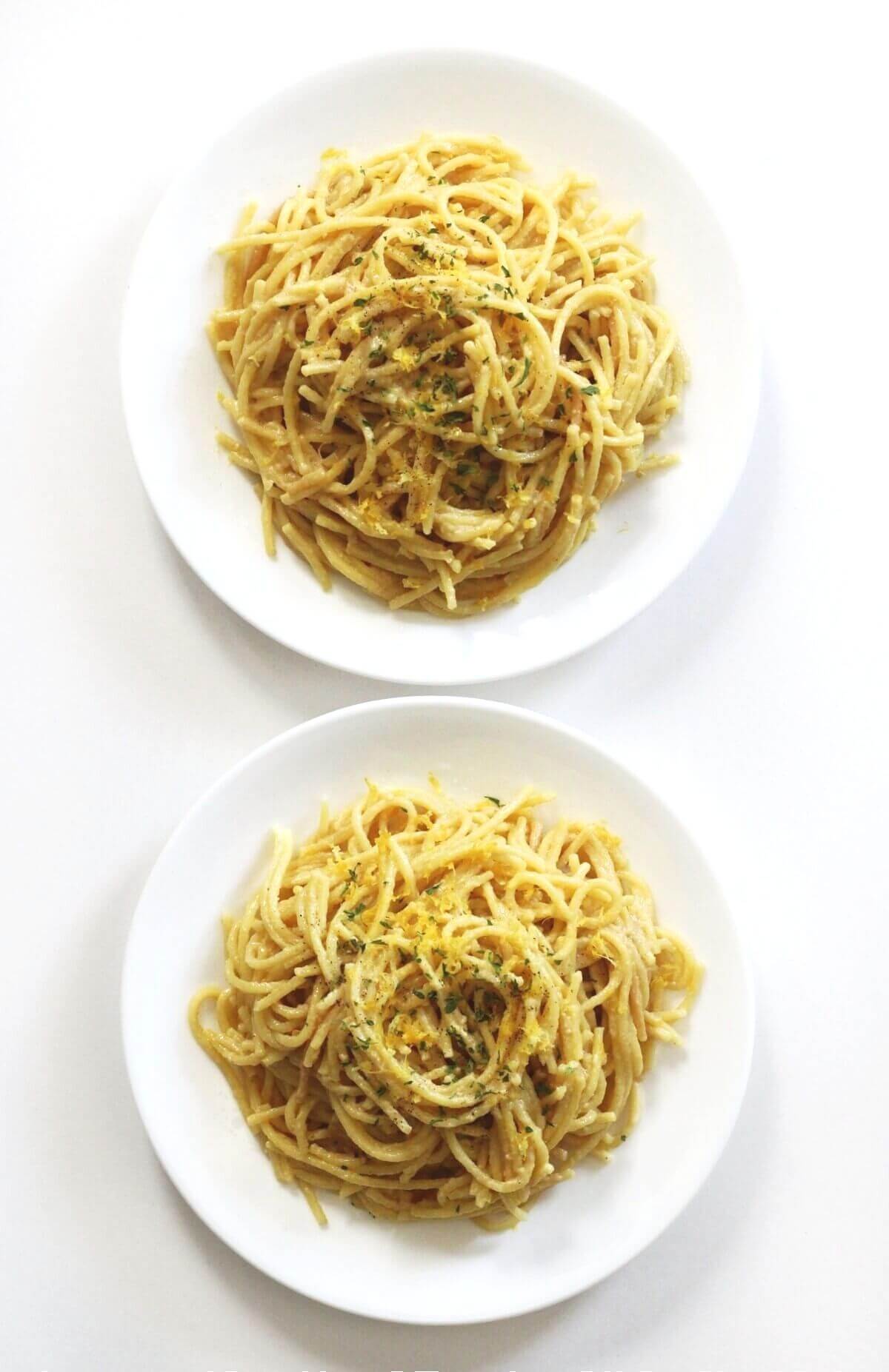 overhead view of two finished plates of vegan pasta al limone