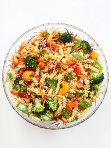 centered overhead view of asian pasta salad in glass bowl